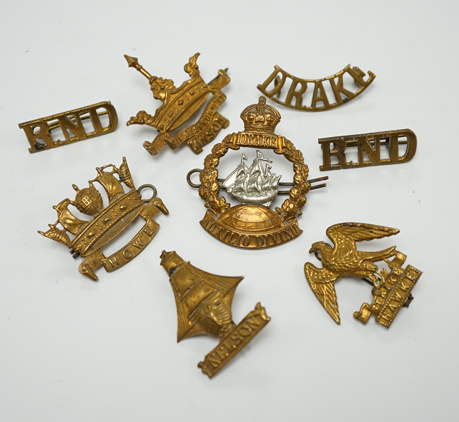 Five Royal Navy First World War brass cap badges; the Nelson, Hawke, Anson and Howe Battalions, together with three shoulder titles. Condition - fair, some possible restrikes.